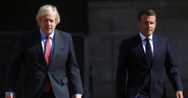 British Prime Minister Boris Johnson (L) and French President Emmanuel Macron walk after watching The Red Arrows and La Patrouille de France perform a flypast, at Horse Guards Parade in London, Britain, June 18, 2020. (EPA-EFE Photo)