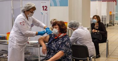 A health care worker administers a dose of Russia's Sputnik V COVID-19 vaccine to a patient at a vaccination center in the GUM State Department store in Moscow, Russia, Oct. 21, 2021. (AFP Photo)