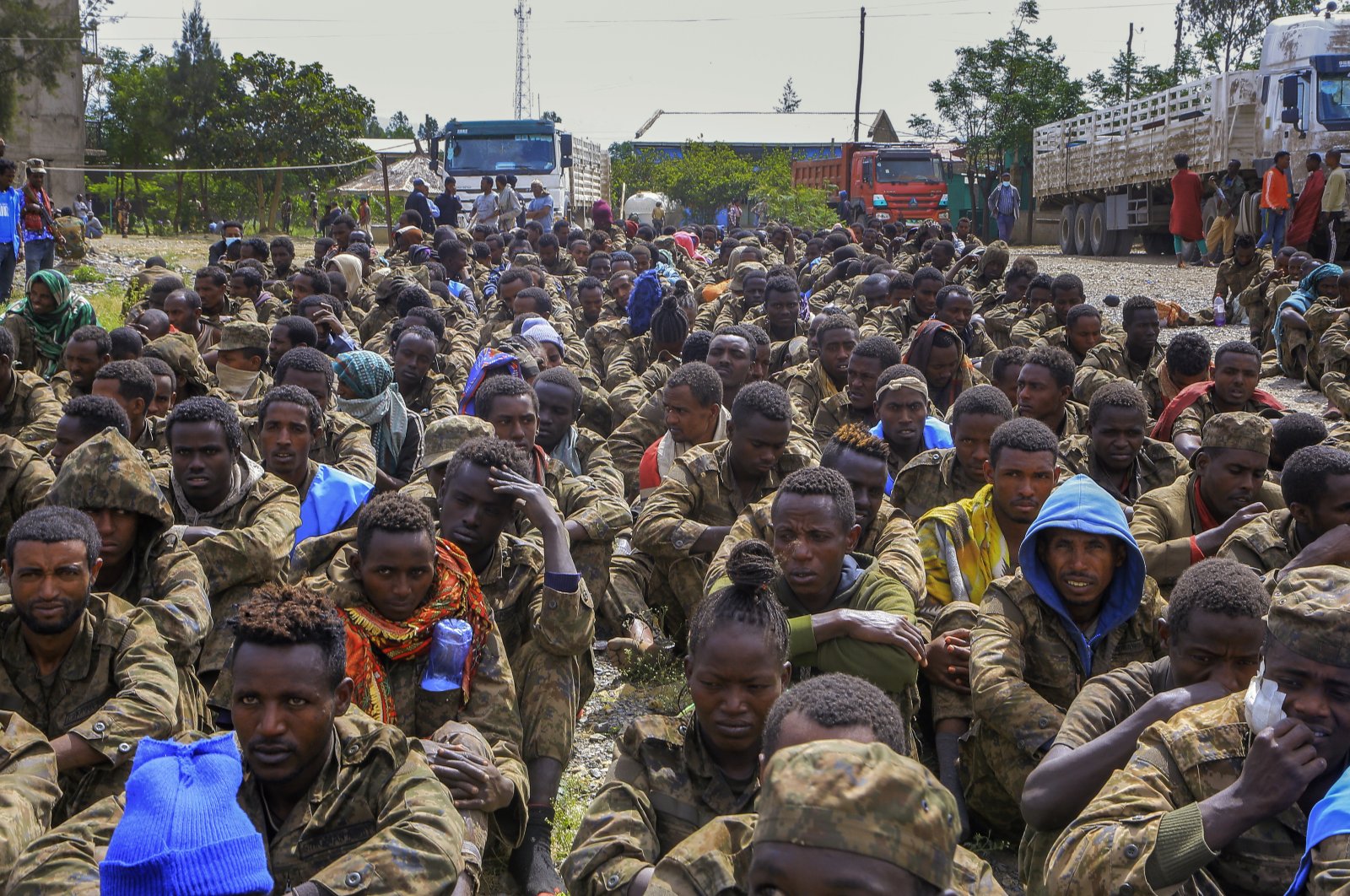Captured Ethiopian government soldiers and allied militia members sit in rows after being paraded by Tigray forces through the streets in open-top trucks, as they arrived to be taken to a detention center in Mekele, the capital of the Tigray region of northern Ethiopia, Oct. 22, 2021. (AP Photo)