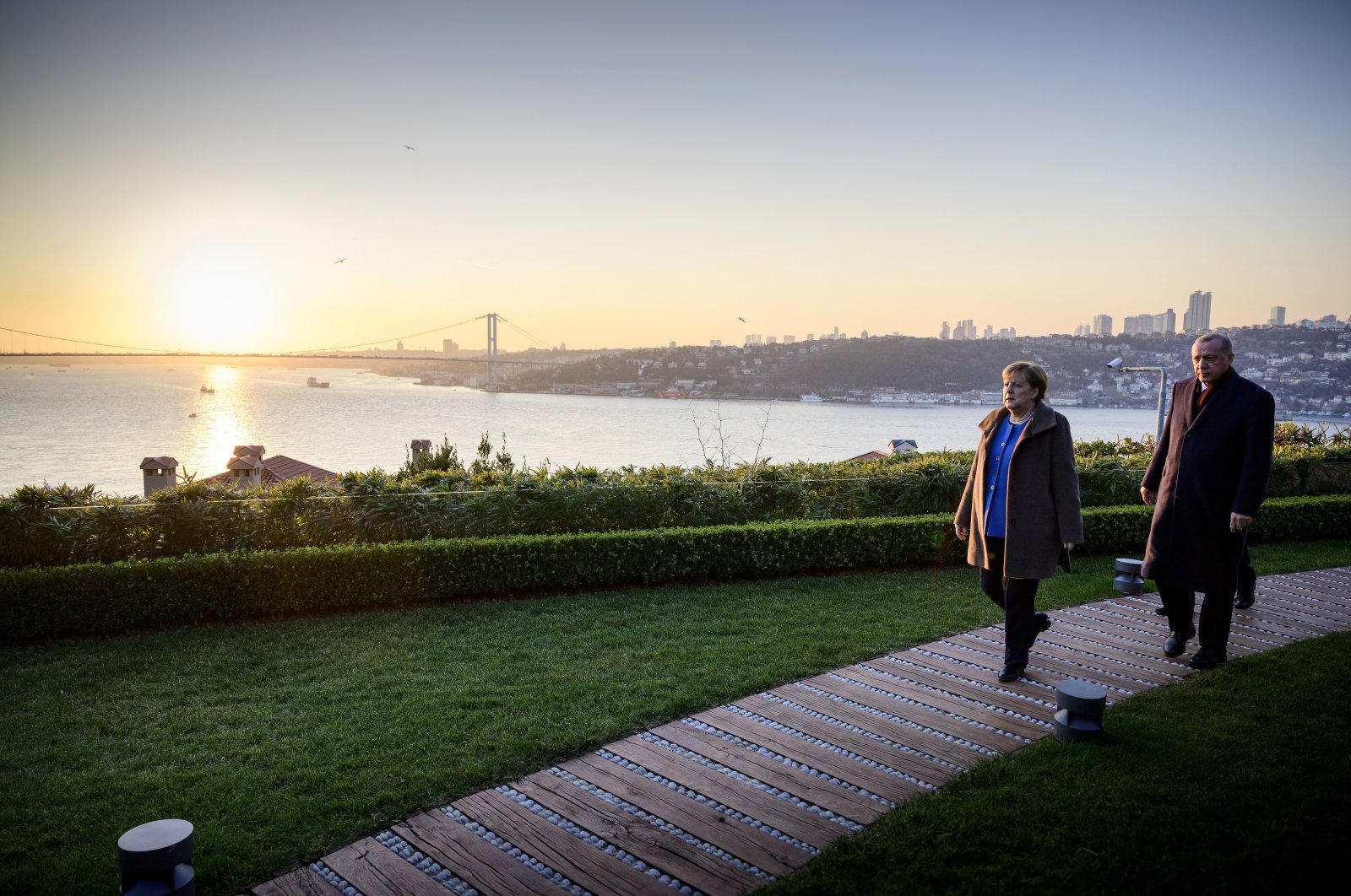 German Chancellor Angela Merkel (L) and President Recep Tayyip Erdoğan walking prior to their meeting on bilateral relations, Istanbul, Turkey, Jan. 24, 2021. (Photo by Getty Images)