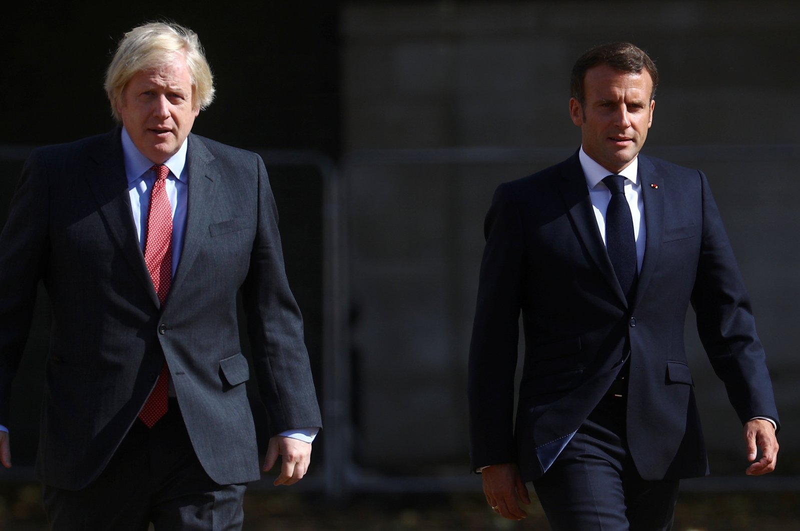 British Prime Minister Boris Johnson (L) and French President Emmanuel Macron walk after watching The Red Arrows and La Patrouille de France perform a flypast, at Horse Guards Parade in London, Britain, June 18, 2020. (EPA-EFE Photo)