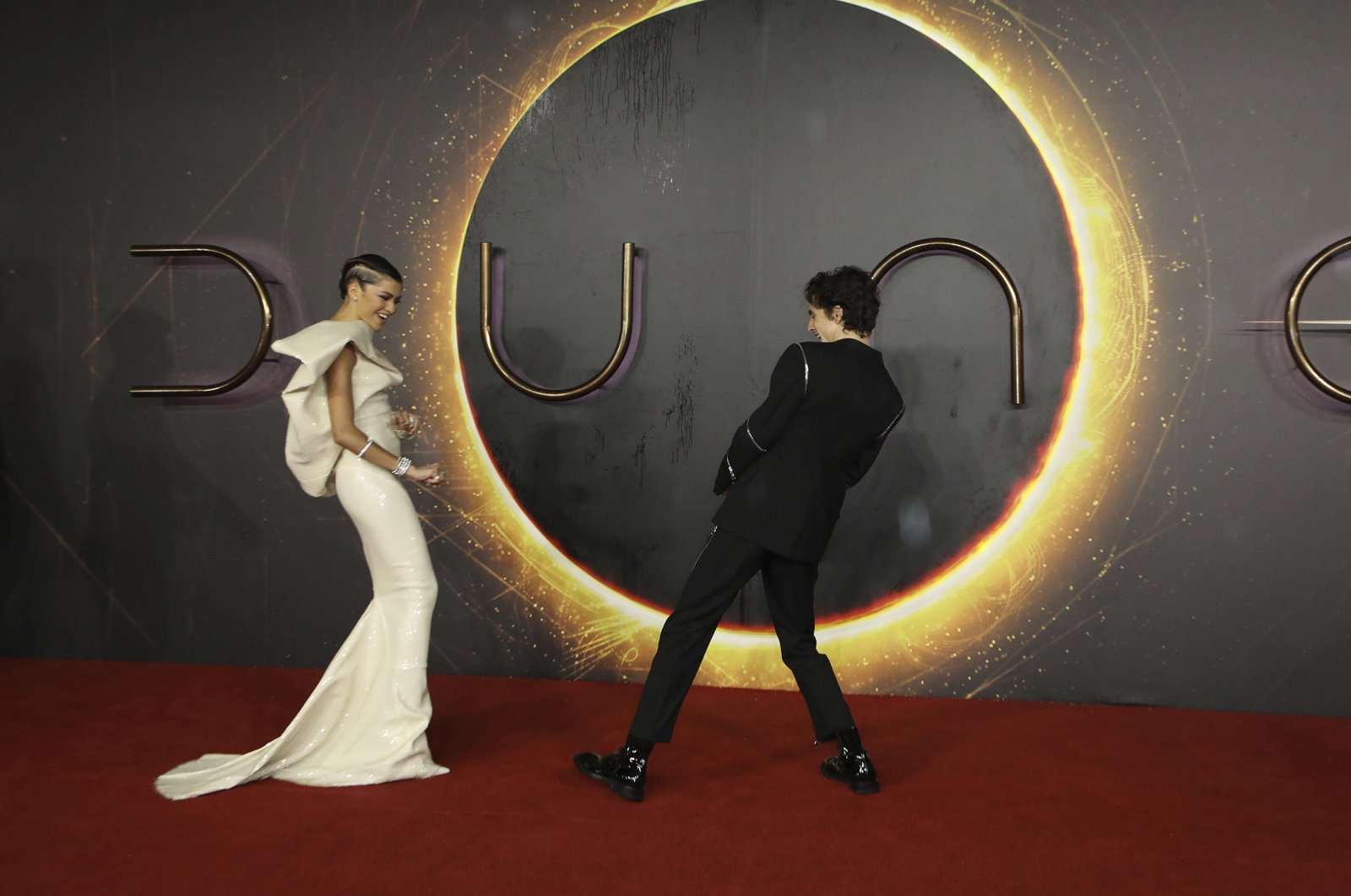 Zendaya (L) and Timothee Chalamet pose for photographers upon arrival at the premiere of the film "Dune," in London, U.K., Oct. 18, 2021. (AP Photo)