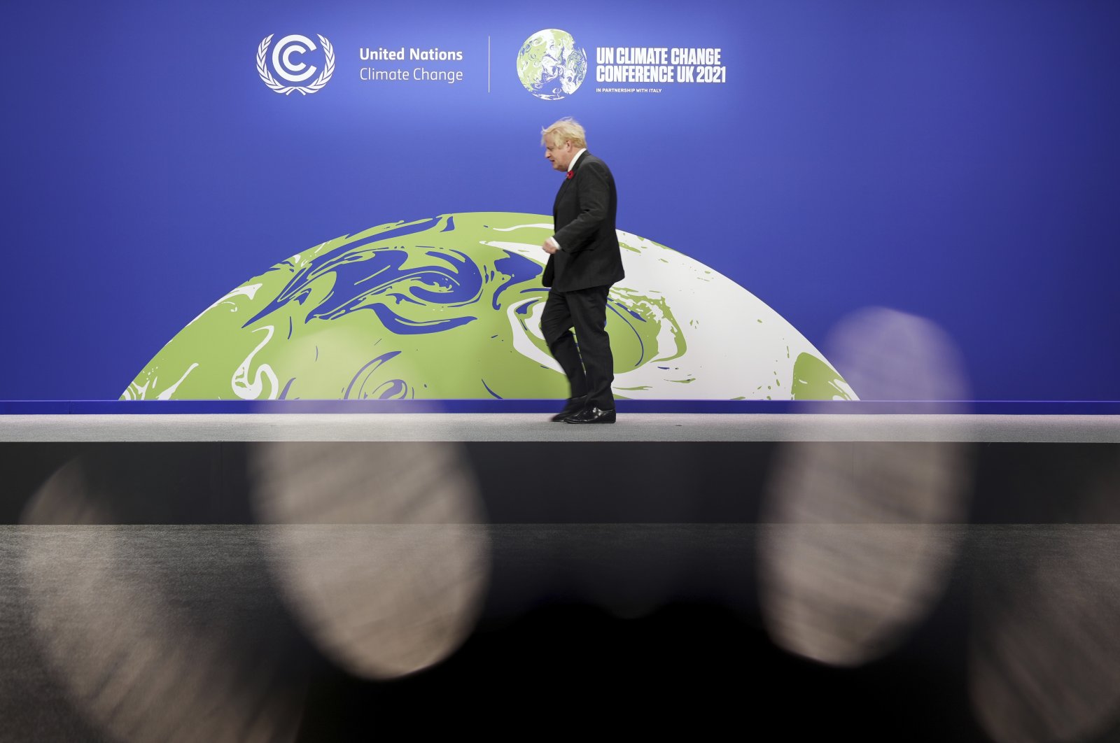 British Prime Minister Boris Johnson looks on as he prepares to receive attendees, at the COP26 U.N. Climate Summit in Glasgow, Scotland, Monday, Nov. 1, 2021. (Christopher Furlong/Pool via AP)