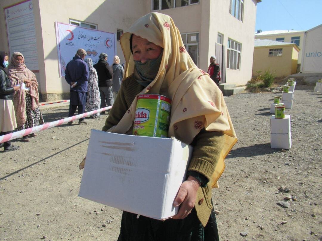 A woman receives food packages distributed by Turkish organizations, Bamyan, Afghanistan, Nov.1, 2021. (AA Photo)