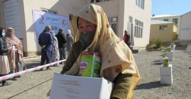 A woman receives food packages distributed by Turkish organizations, Bamyan, Afghanistan, Nov.1, 2021. (AA Photo)