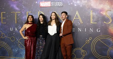 Director Chloe Zhao (C-L) poses with cast members Salma Hayek (L), Angelina Jolie (C-R) and Barry Keoghan as they arrive for a screening of the film "Eternals" in London, U.K., Oct. 27, 2021. (Reuters Photo)