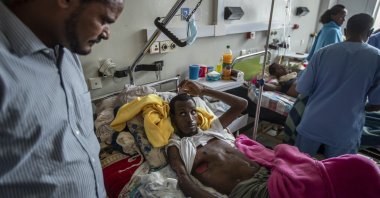 Farmer Teklemariam Gebremichael, who said he was shot by Eritrean forces in Enticho six months before and was still recovering, speaks to a doctor (L) at the Ayder Referral Hospital in Mekele, in the Tigray region of northern Ethiopia on May 6, 2021. (AP Photo)