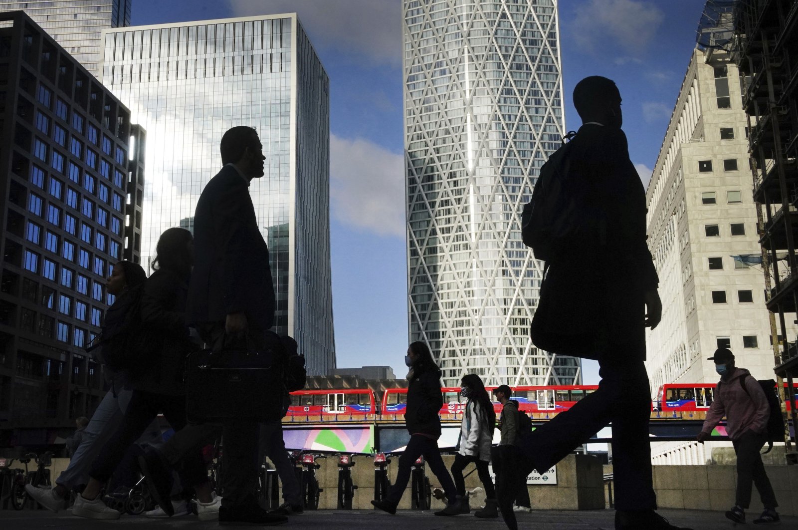 Office workers and commuters walk through Canary Wharf, during the morning rush hour, in London, U.K., Oct. 6, 2021. (AP Photo)