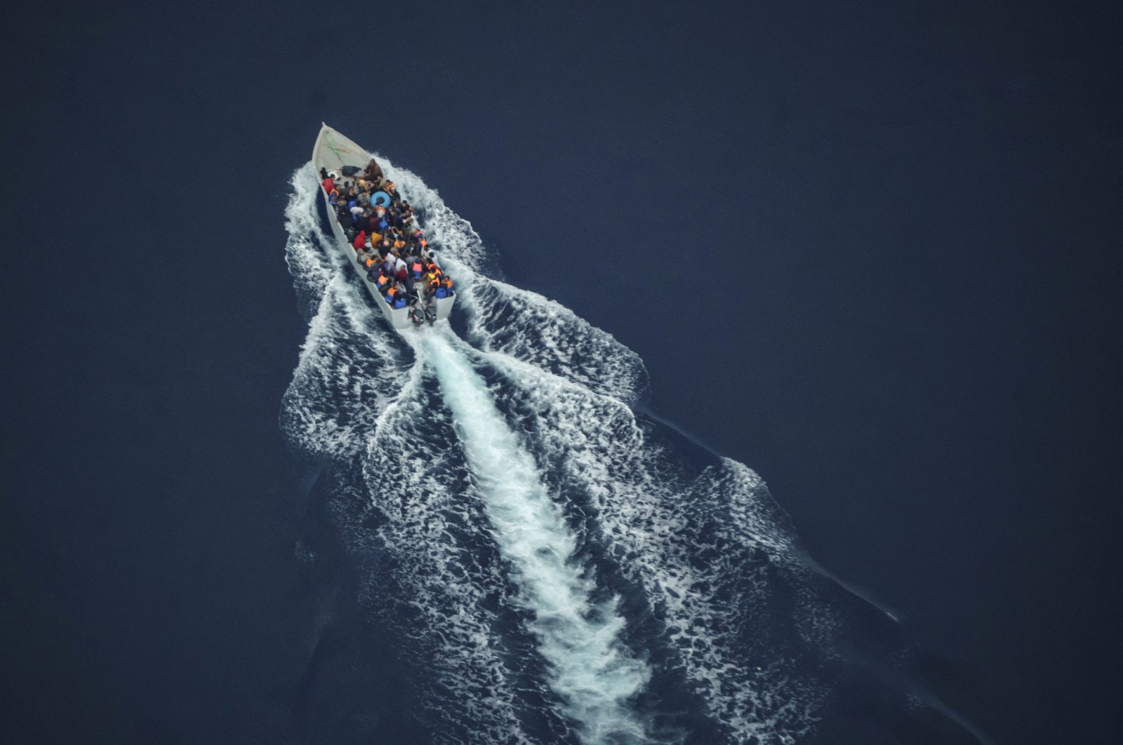 Migrants navigate on an overcrowded wooden boat in the Central Mediterranean Sea between North Africa and the Italian island of Lampedusa, Oct. 2, 2021. (AP Photo)