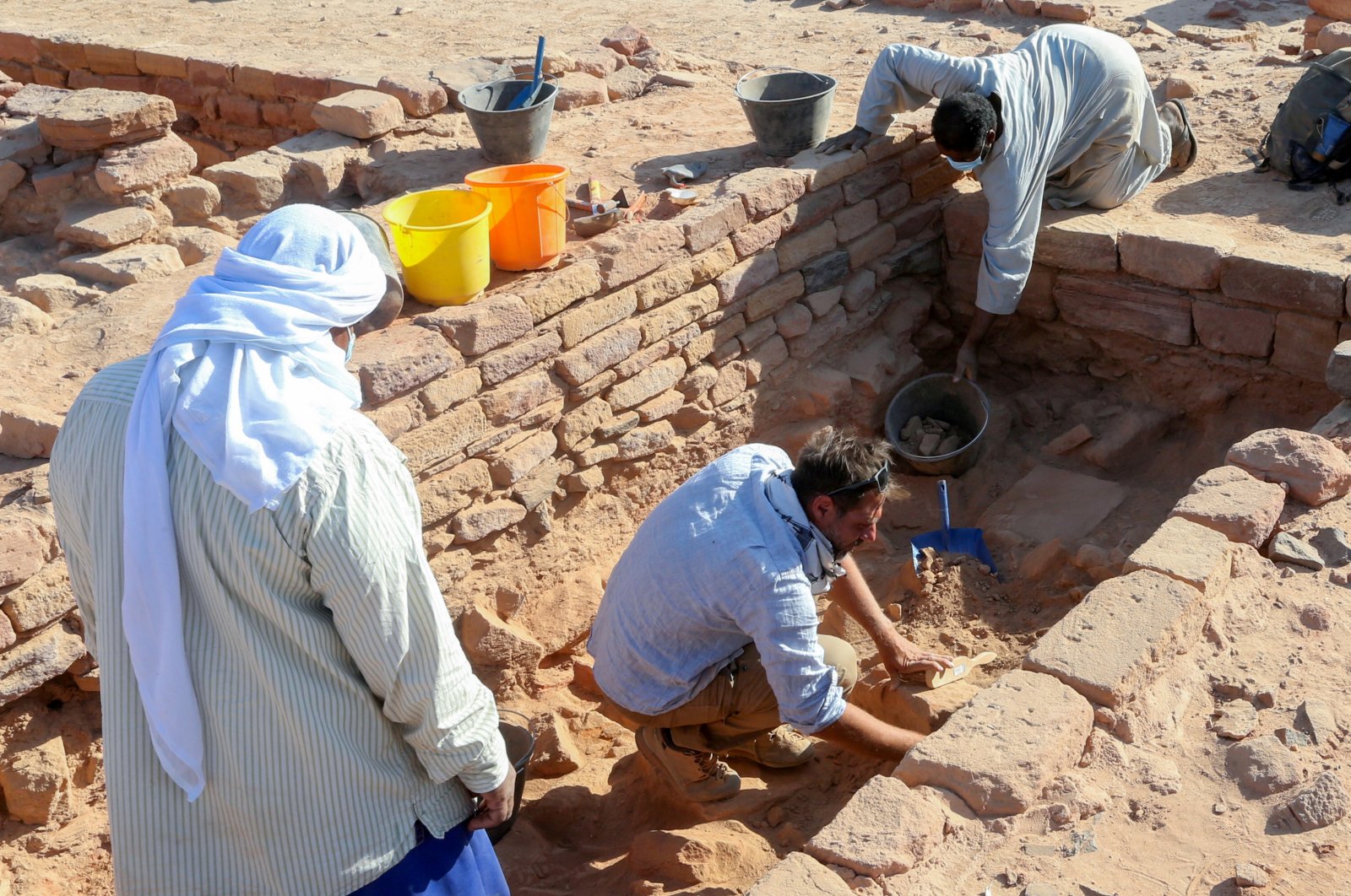 A French archaeologist and his co-workers carefully clean the pottery to examine the findings known to be from the Dadan and Lihyan civilization dated 1,000 B.C., Al-Ula, Saudi Arabia, Oct. 30, 2021. (Reuters Photo)