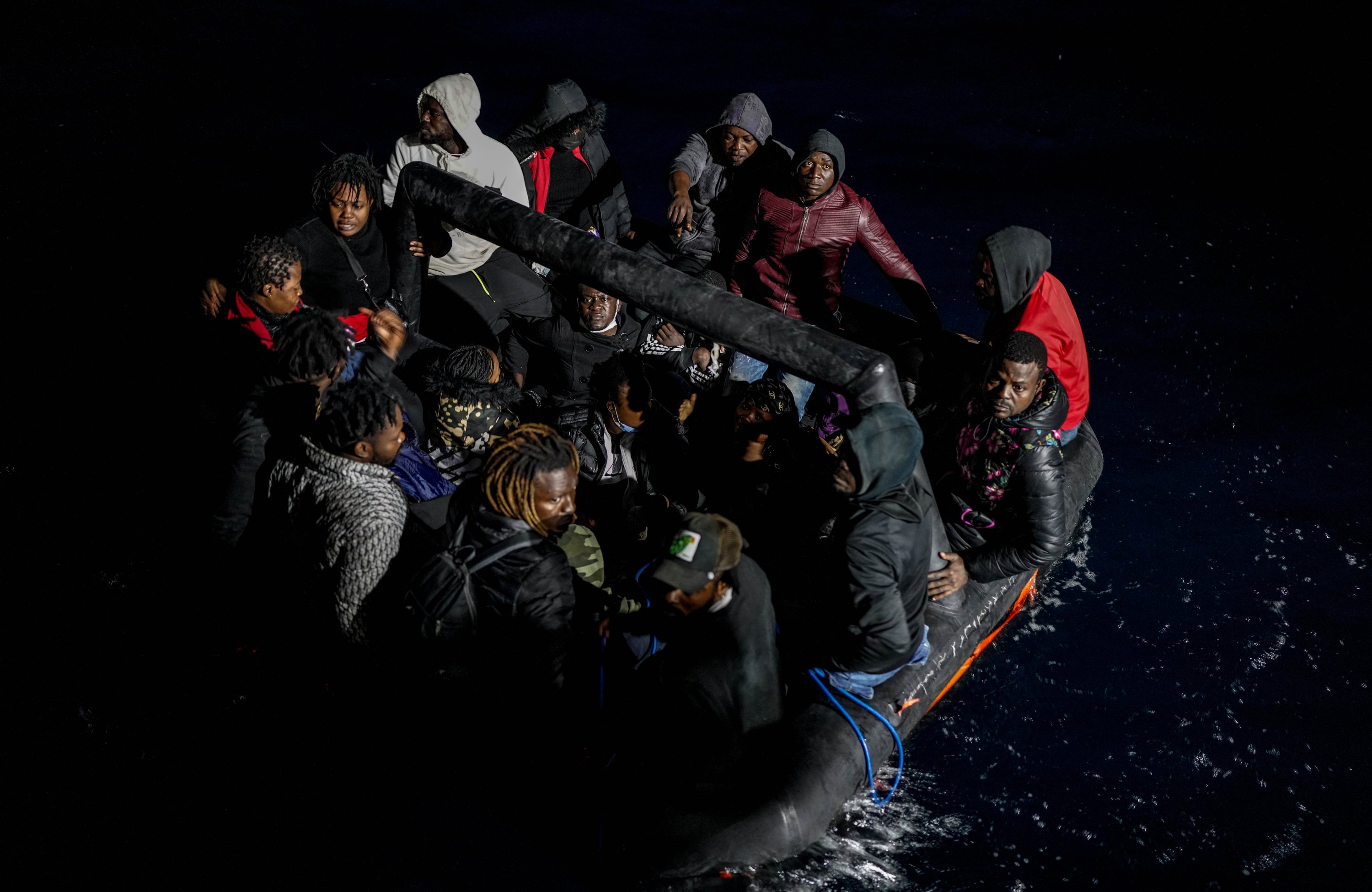 Migrants pushed back by Greece are seen on a rubber boat in the Aegean Sea, Turkey, Nov. 3, 2021. (Photo by Uğur Yıldırım)