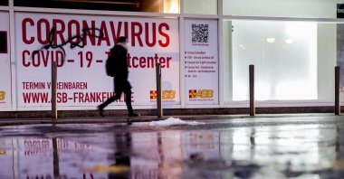 A woman walks past an abandoned coronavirus test center in Frankfurt, Germany, Nov. 2, 2021. (AP Photo)