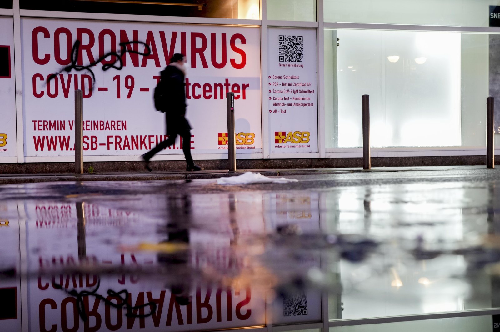 A woman walks past an abandoned coronavirus test center in Frankfurt, Germany, Nov. 2, 2021. (AP Photo)