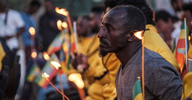 A man holds a candle during a memorial service for the victims of the Tigray conflict organized by the city administration, in Addis Ababa, Ethiopia, Nov. 3, 2021. (AFP Photo)