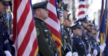 Members of law enforcement display flags outside the SNHU Arena before a Celebration of Life service for fallen N.H. State Police Staff Sergeant Jesse Sherrill, Manchester, New Hampshire, U.S., Nov. 3, 2021. (AP Photo)