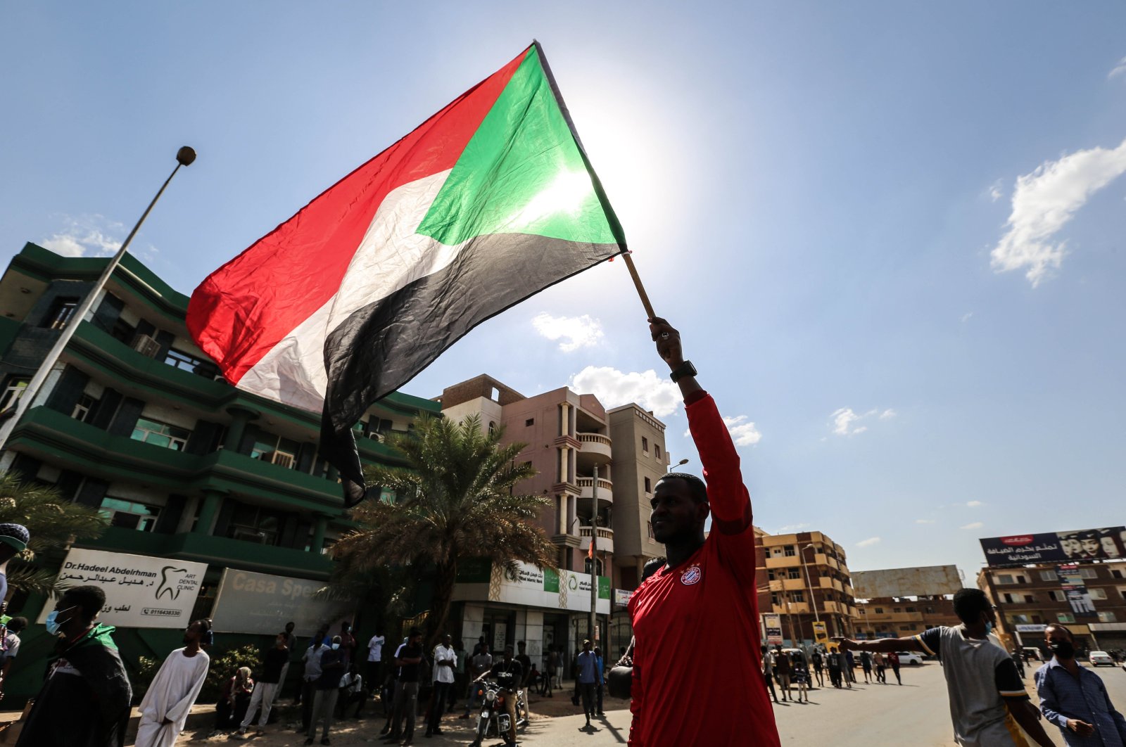 A Sudanese protestor waves a national flag as people gather in a rally against the military coup, in the capital Khartoum, Sudan, Oct. 30, 2021. (AA Photo)