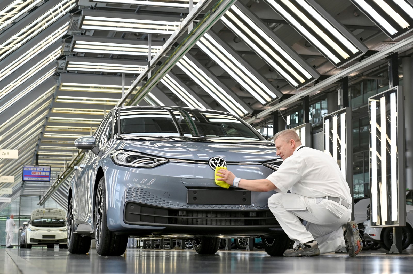 Technicians work in the final inspection line of German carmaker Volkswagen's electric car in Dresden, Germany, June 8, 2021. (Reuters Photo)