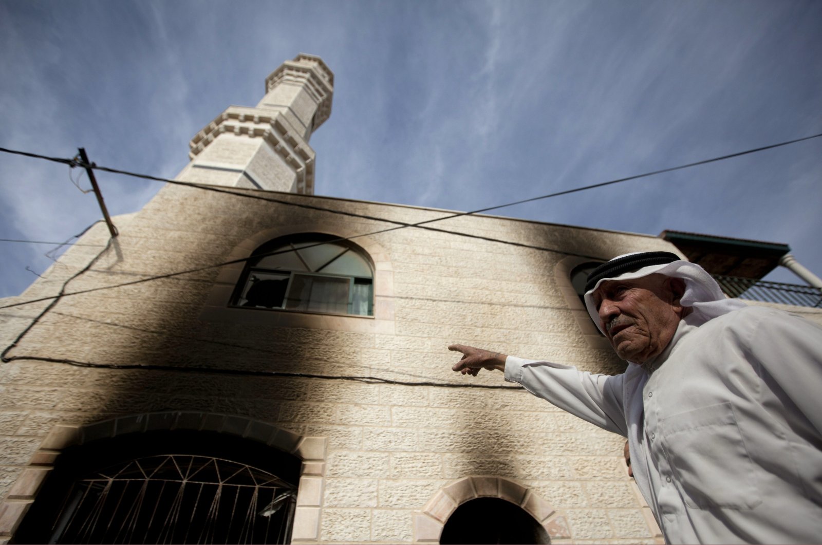 Palestinians inspects the damage on a mosque following an attack in the West Bank village of Mughayer, north of Ramallah, West Bank, occupied Palestine, Nov. 12, 2014. (AP Photo)