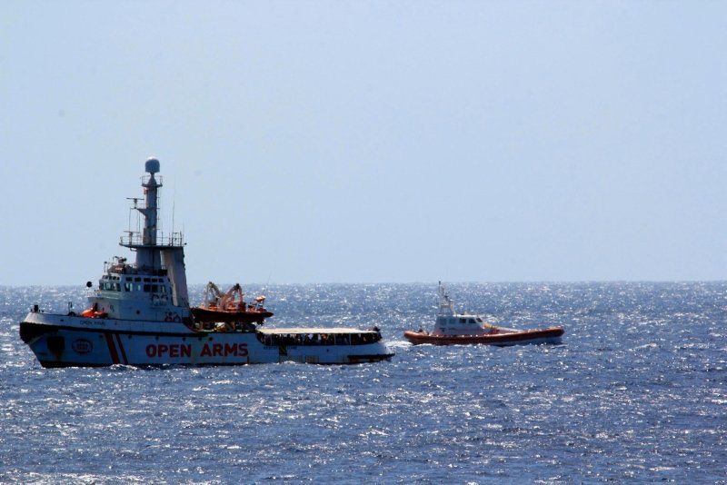 The Open Arms Spanish humanitarian boat with 147 migrants (L) is monitored by an Italian Coast guard vessel as it sails off the coasts of the Sicilian island of Lampedusa, southern Italy, Aug. 15, 2019. (AP)