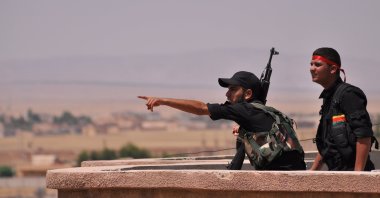 YPG terrorists monitor the horizon in the northeastern city of Hasakah, Syria, on June 28, 2015. (AFP Photo)