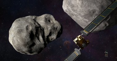 This artist's illustration obtained from NASA on Nov. 4, 2021 shows the DART spacecraft and the Italian Space Agency (ASI) LICIACube prior to impact at the Didymos binary system. (NASA/Johns Hopkins APL/Steve Gribben' via AFP Photo) 