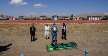 An imam and cemetery workers perform funeral prayers for an unidentified migrant, in Van, eastern Turkey, Oct. 7, 2021. (PHOTO BY UĞUR YILDIRIM)
