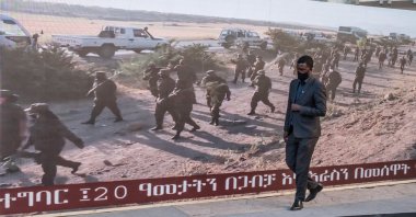 A man walks along a screen featuring soldiers during a memorial service for the victims of the Tigray conflict organized by the city administration, in Addis Ababa, Ethiopia, Nov. 3, 2021. (AFP Photo)