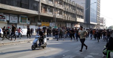 Supporters of Iraqi Shiite armed groups run from security forces after clashes during a protest against the election results in Baghdad, Iraq, Nov. 5, 2021. (Reuters Photo)