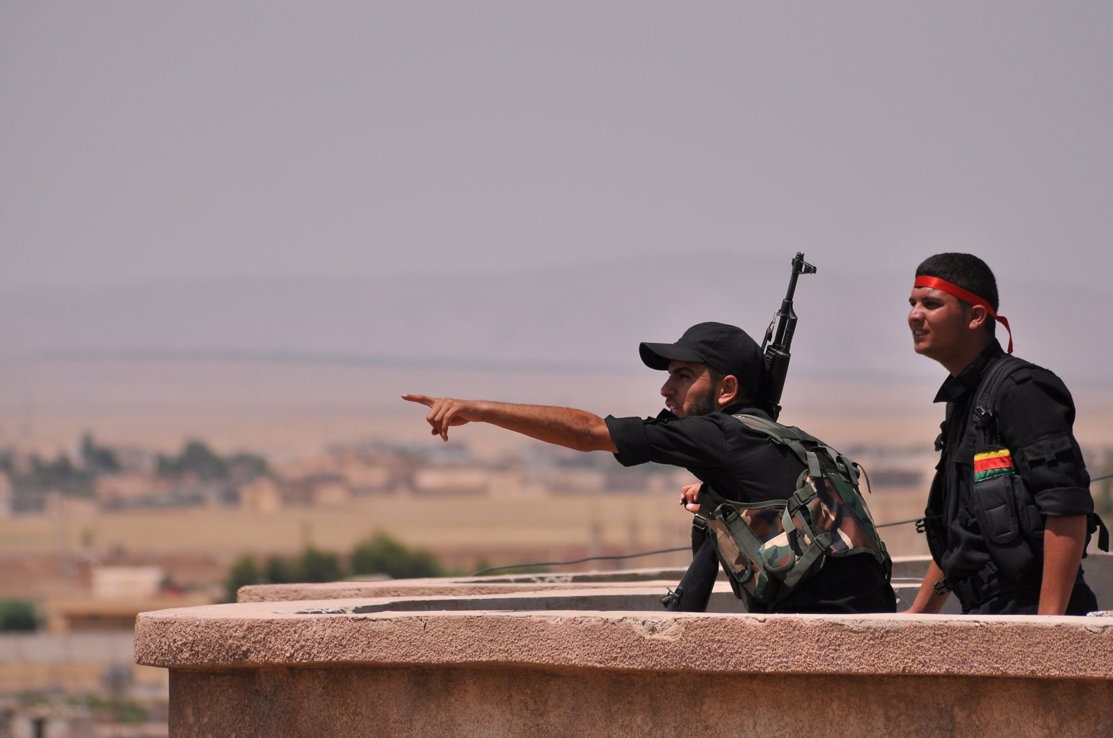YPG terrorists monitor the horizon in the northeastern city of Hasakah, Syria, on June 28, 2015. (AFP Photo)