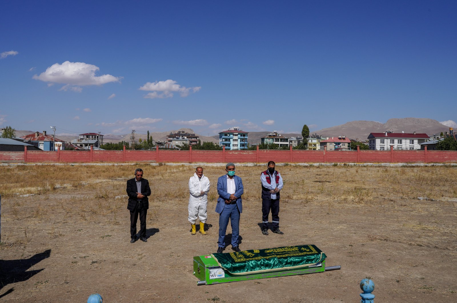 An imam and cemetery workers perform funeral prayers for an unidentified migrant, in Van, eastern Turkey, Oct. 7, 2021. (PHOTO BY UĞUR YILDIRIM)