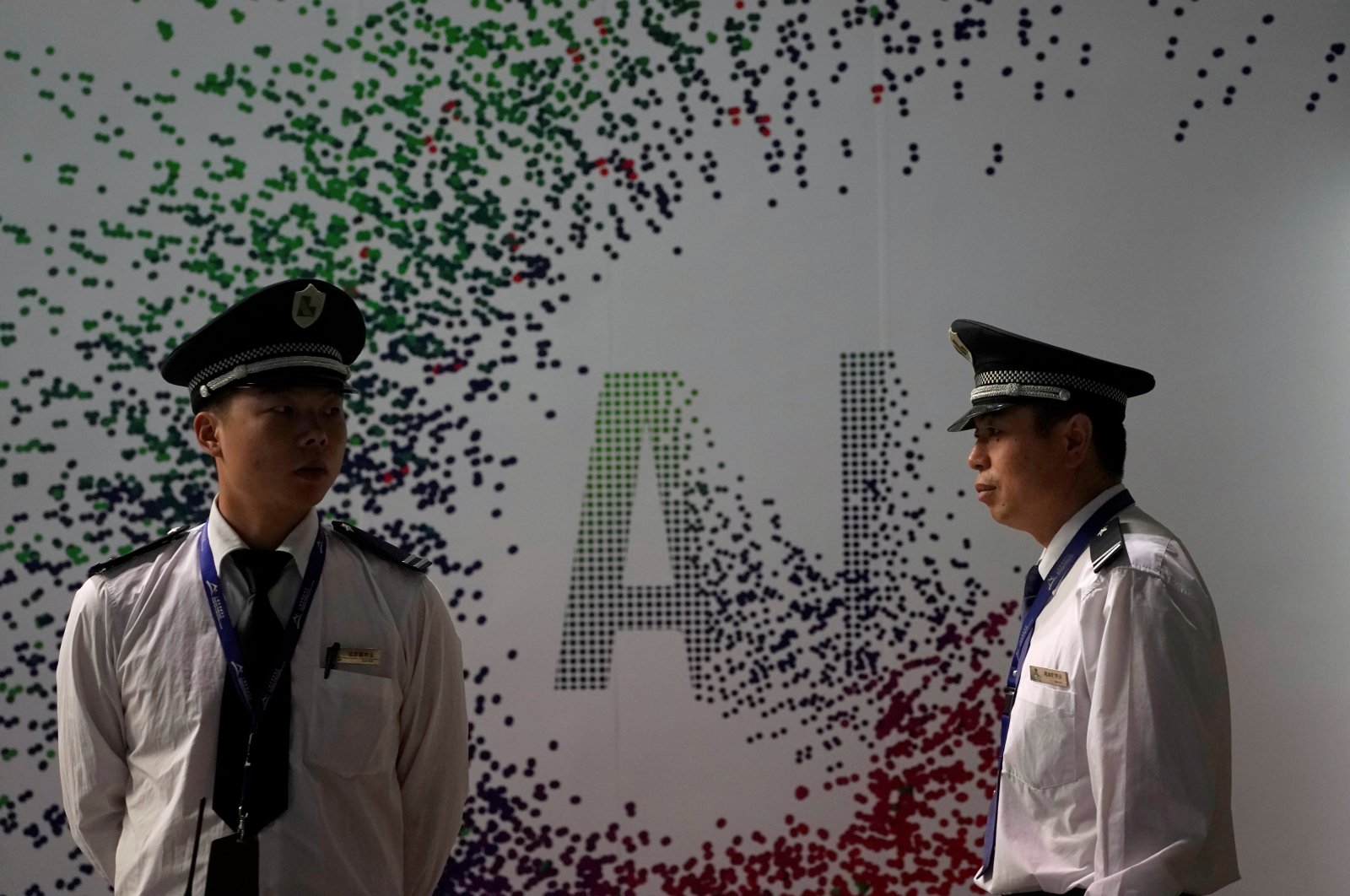 Security officers keep watch in front of an AI (Artificial Intelligence) sign at the annual Huawei Connect event in Shanghai, China, Sept. 18, 2019. (Reuters Photo)