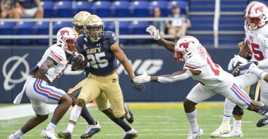 Navy Midshipmen fullback Carlinos Acie (25) runs as wide receiver Cal Long (88) blocks Southern Methodist Mustangs cornerback Bryan Massey (0) during the first half at Navy-Marine Corps Memorial Stadium, Annapolis, Maryland, U.S., Oct. 9, 2021. (Tommy Gilligan-USA TODAY Sports via Reuters)