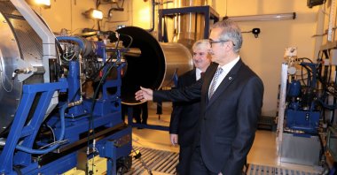 Presidency of Defense Industries (SSB) head Ismail Demir (R) and the head of Turkish Aerospace Industries (TAI), Mahmut Faruk Akşit, inspect the T700-TEI-701D engine production in the TUSAŞ factory in Eskişehir, Turkey, May 14, 2019. (AA Photo)