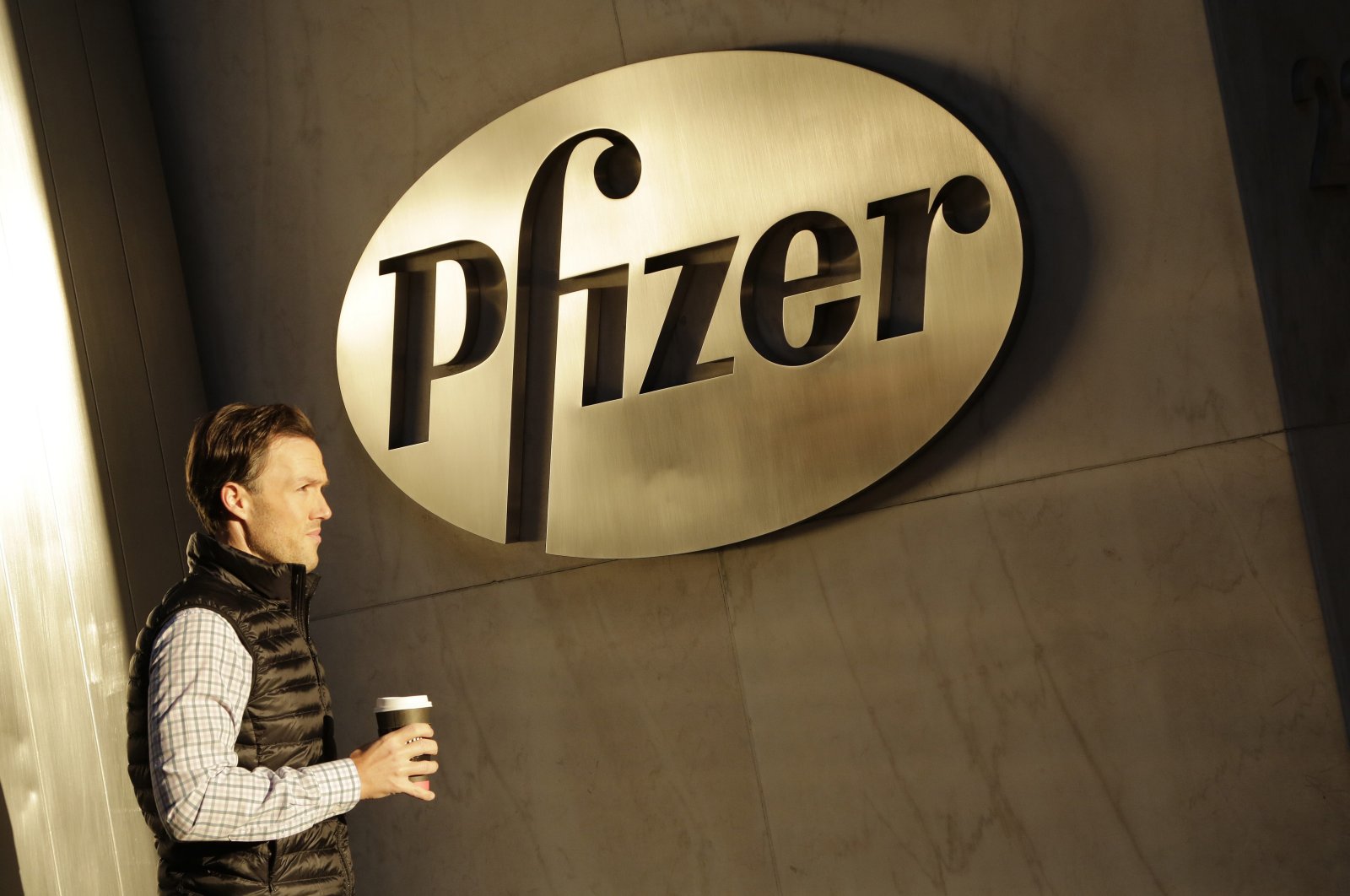 In this Nov. 23, 2015, file photo, a man enters Pfizer's world headquarters, in New York City, U.S. (AP Photo)