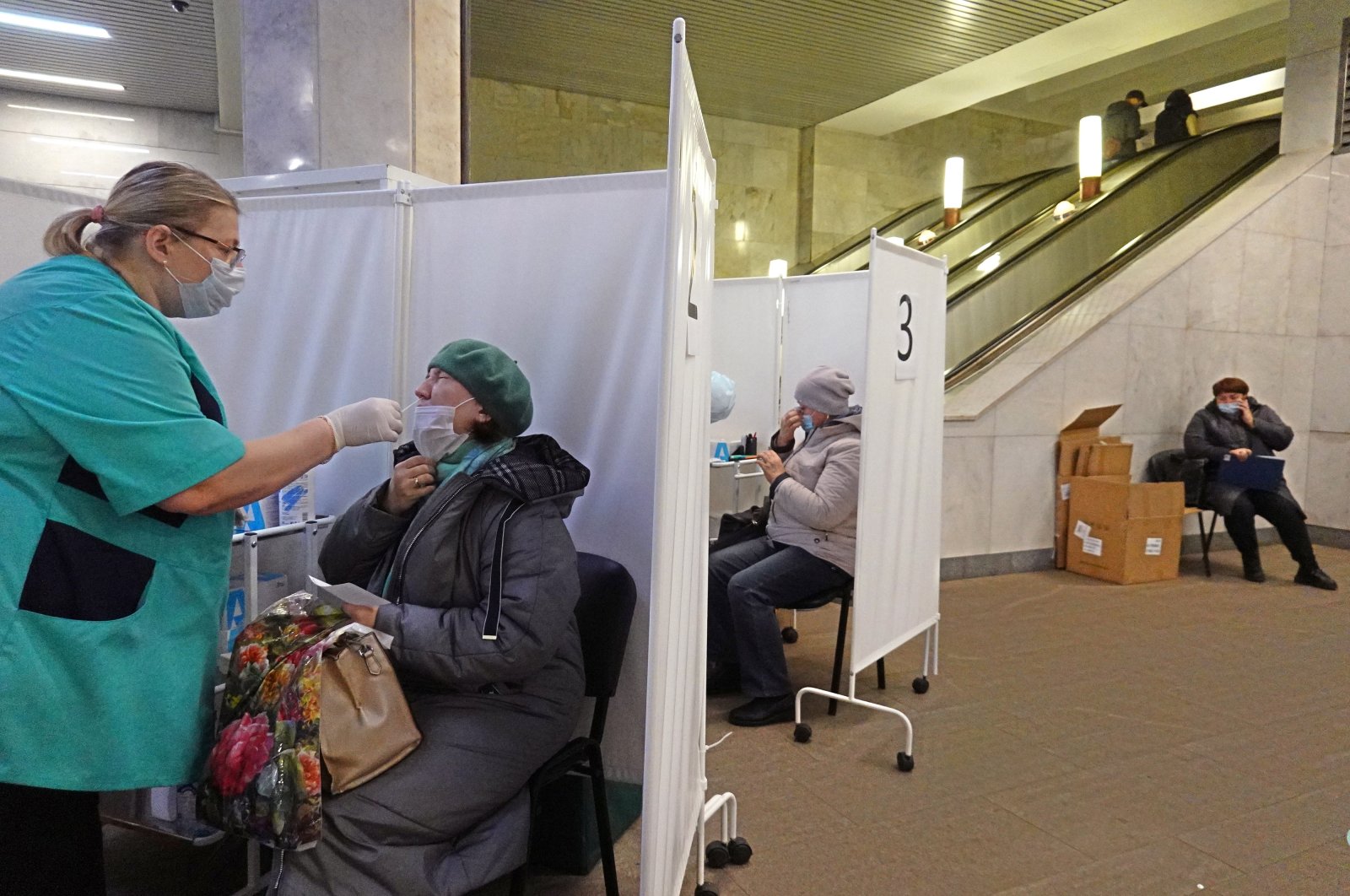 A woman undergoes COVID-19 testing at a "coronavirus express test point" in a Metro during coronavirus pandemic in Moscow, Russia, Nov. 3, 2021. (EPA Photo)