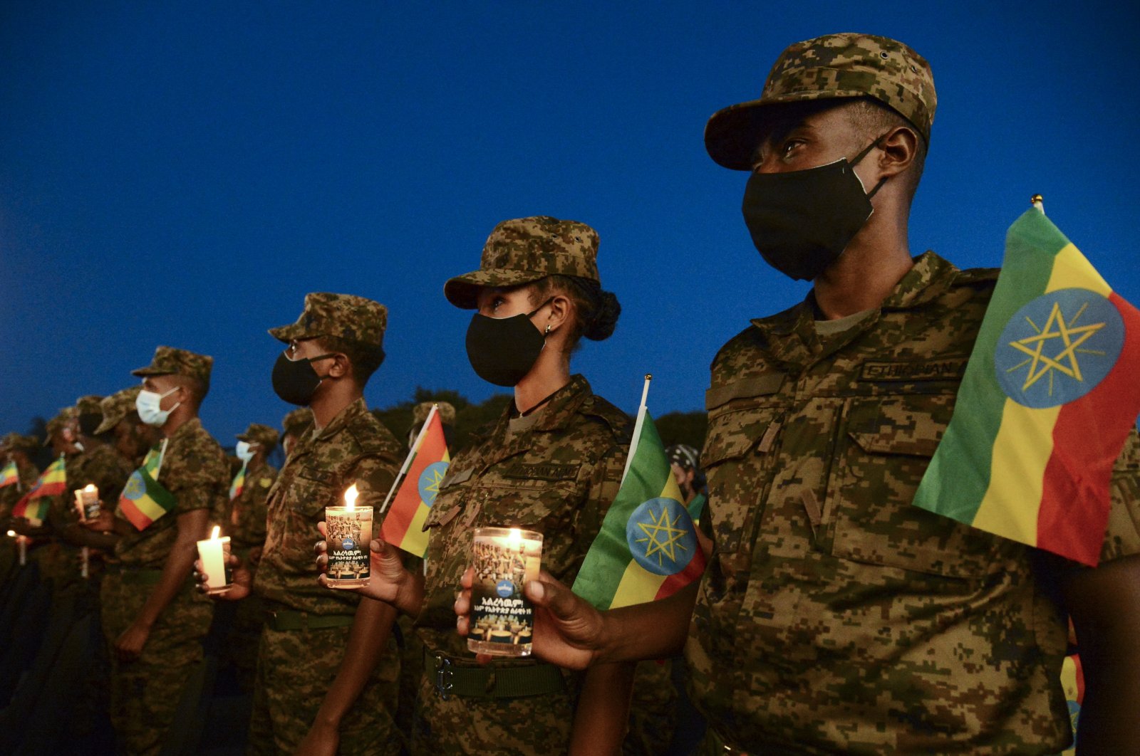 Current and former Ethiopian military personnel and the public commemorate federal soldiers killed by forces loyal to the Tigray People's Liberation Front (TPLF) at the start of the conflict one year ago, at a candlelit event outside the city administration in Addis Ababa, Ethiopia, Nov. 3, 2021. (AP Photo)