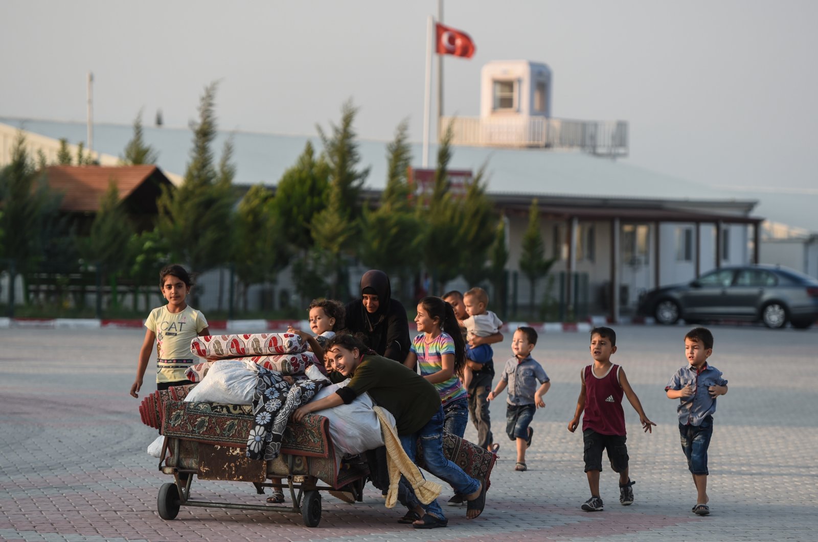 A Syrian family carries their furniture at the Boynuyogun refugee camp in Hatay, Turkey, Sept. 16, 2019. (Getty Images)