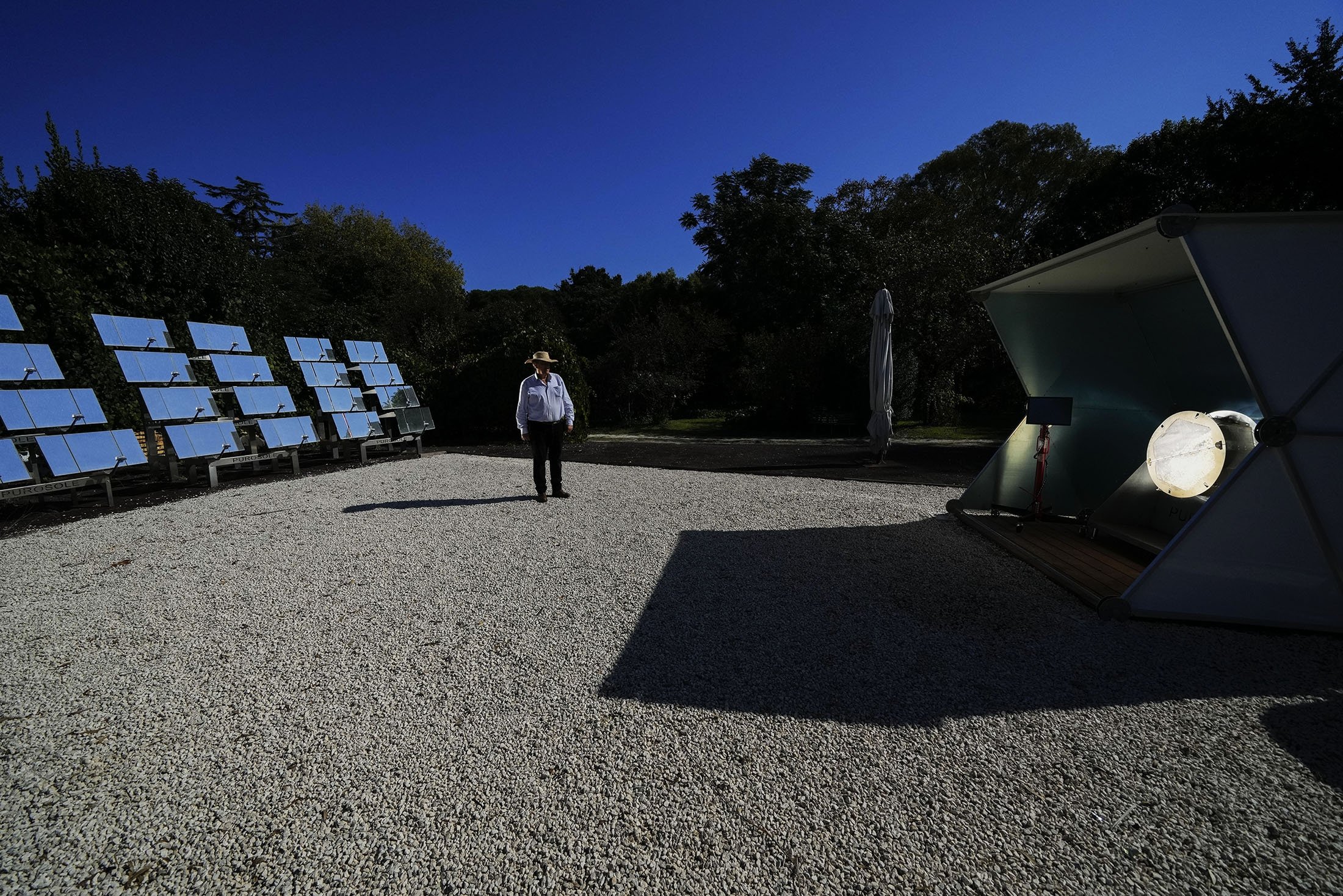 Antonio Durbe monitors the functioning of the 'Purosole,' or Pure Sun, solar light coffee roaster, in Rome, Italy, Oct. 13, 2021. (AP Photo)