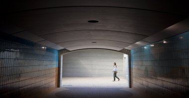 A young woman walks past an underground passage, Abu Dhabi, United Arab Emirates. (Getty Images)