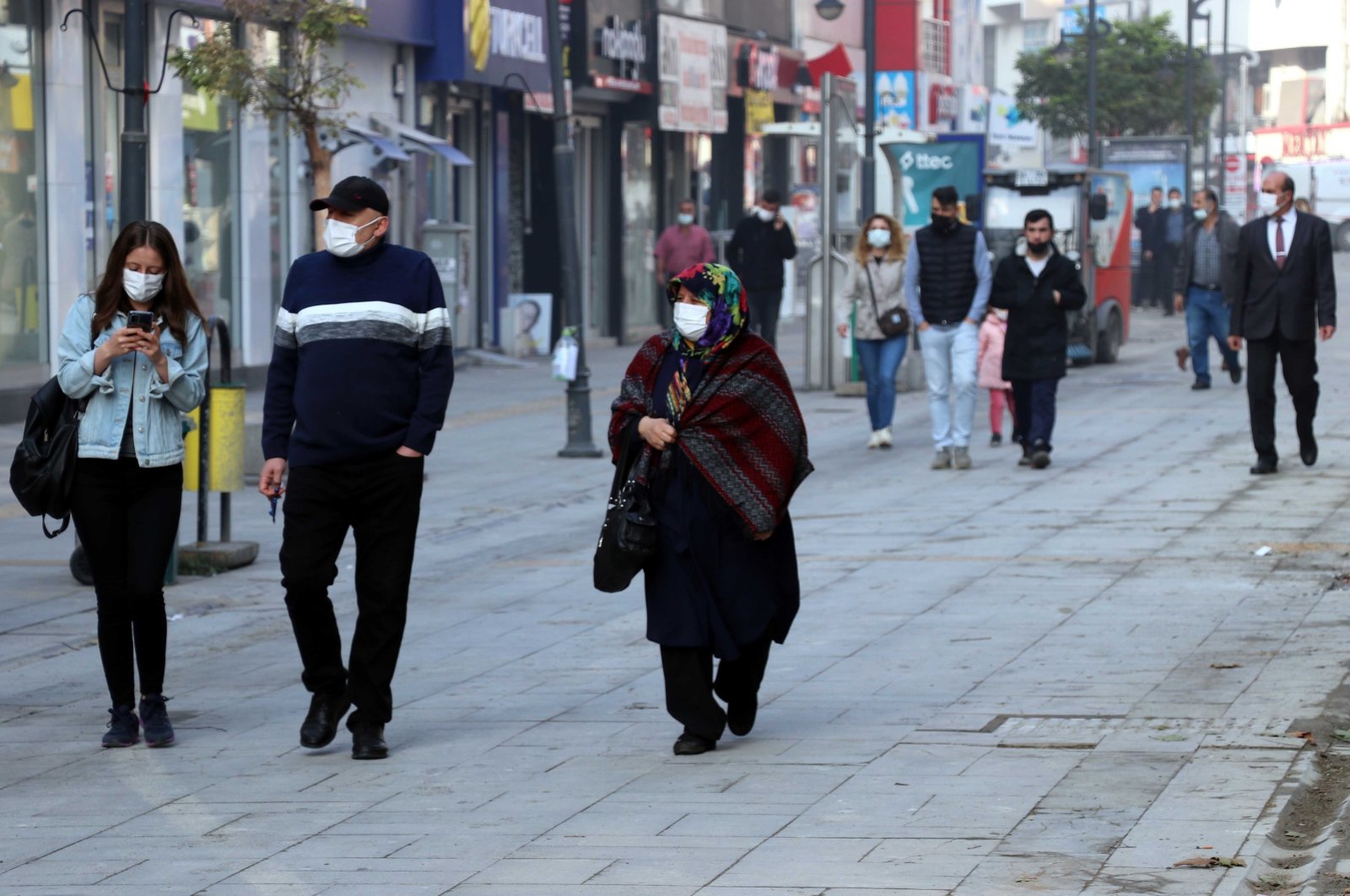People wearing protective masks against COVID-19 walk on a street, in Karabük, northern Turkey, Nov. 5, 2021. (AA PHOTO) 