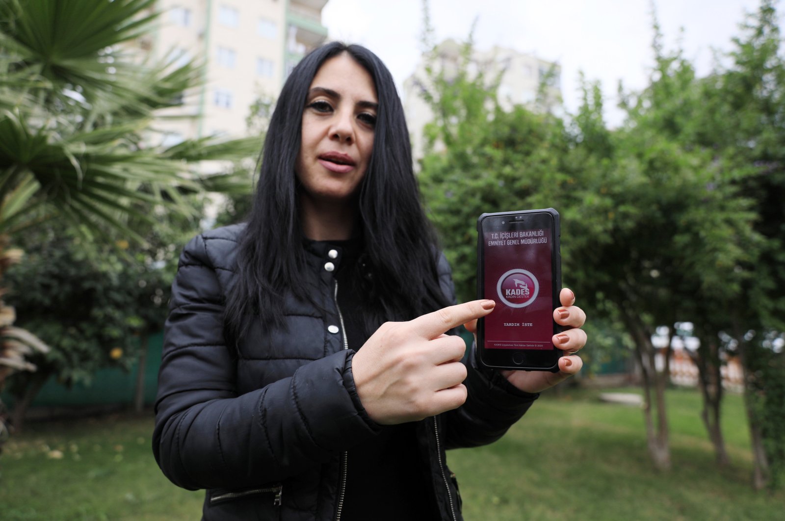Ayşe Kasanova, who used the app to alert police against her violent ex-husband, shows KADES on her cellphone, in Antalya, southern Turkey, Aug. 11, 2021. (DHA PHOTO) 
