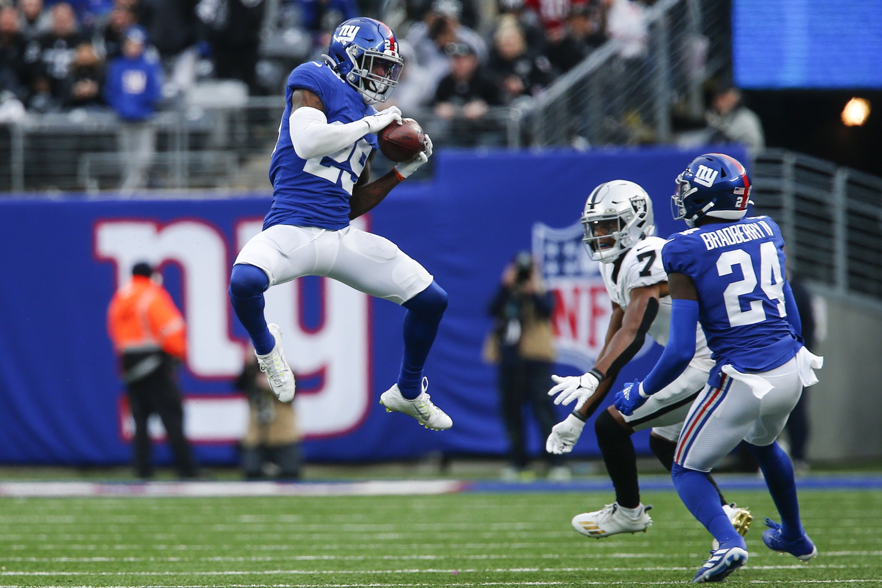 New York Giants free safety Xavier McKinney (29) intercepts a pass intended for Las Vegas Raiders' Zay Jones (7) as Giants' James Bradberry (24) watches during the second half of an NFL football game, East Rutherford, New Jersey, U.S., Nov. 7, 2021. (AP Photo)