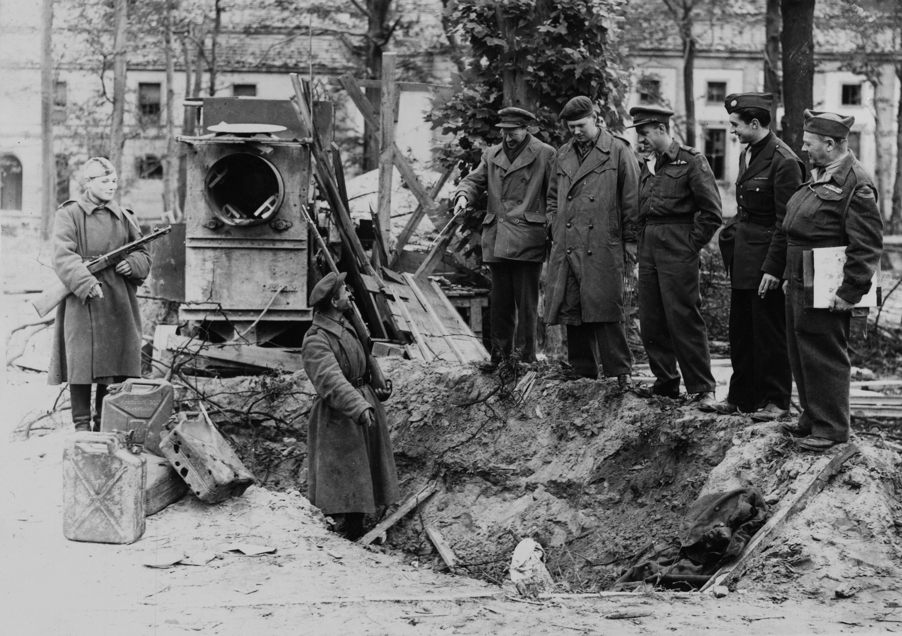 War correspondents are shown the grave where Adolf Hitler's charred body is alleged to have been buried in Berlin. (Getty Images)