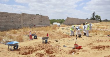 Libyan Ministry of Justice employees dig at a site of a suspected mass grave in the town of Tarhuna, Libya, June 23, 2020. (AP Photo)