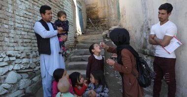 Shabana Maani administers a polio vaccine to a child in the old city of Kabul, Afghanistan, March 29, 2021. (AP Photo)