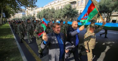 People take part in a procession marking the anniversary of the end of the 2020 military conflict over the Nagorno-Karabakh region, in Baku, Azerbaijan, November 8, 2021. REUTERS/Aziz Karimov