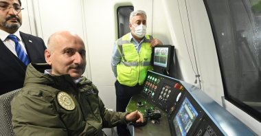 Minister of Transportation and Infrastructure Adil Karaismailoğlu drives the train in a test ride, in Istanbul, Turkey, Nov. 8, 2021. (PHOTO BY BARIŞ SAVAŞ) 