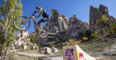 A biker jumps off a ramp in the Red Bull Dawn till Dusk mountain bike race in central Turkey's Capadoccia, Oct. 23, 2021. (Reuters Photo/Red Bull)