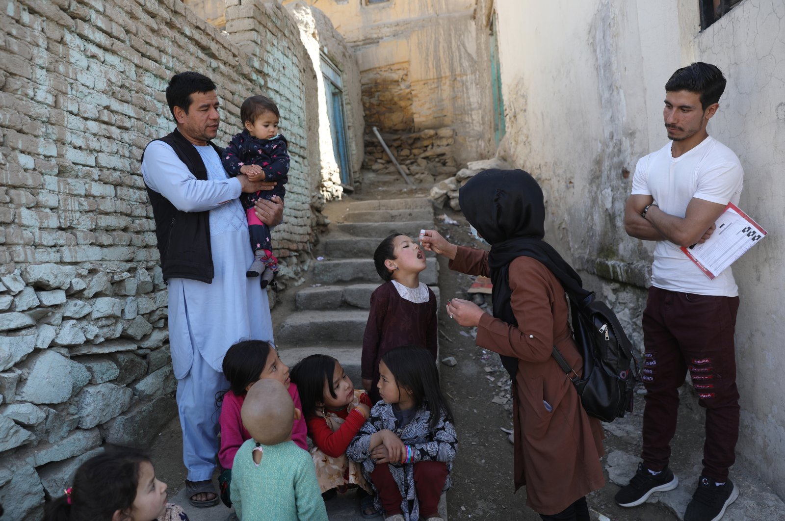 Shabana Maani administers a polio vaccine to a child in the old city of Kabul, Afghanistan, March 29, 2021. (AP Photo)