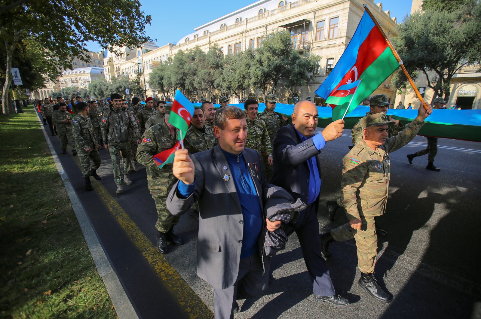 People take part in a procession marking the anniversary of the end of the 2020 military conflict over the Nagorno-Karabakh region, in Baku, Azerbaijan, November 8, 2021. REUTERS/Aziz Karimov
